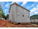 A back corner view of a two story house, focusing on its gray siding against a cloudy sky at 530 Gantt St, Mooresville, NC 28115