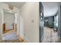 Bright hallway with modern vinyl flooring, featuring a decorative mirror and an inviting 'Welcome' sign at 5938 Mundy Rd, Denver, NC 28037