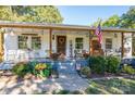 Inviting covered porch features ample seating, decorative touches, and a warm, welcoming atmosphere at 6312 Bill Ledford Rd, Vale, NC 28168