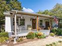 Cozy front porch with rocking chairs, vintage decor, and lovely landscaping, creating a relaxing space at 6312 Bill Ledford Rd, Vale, NC 28168