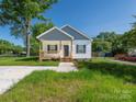 Charming single-story home with a cozy front porch and fresh landscaping at 803 Blackmon St, Rock Hill, SC 29730