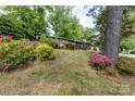 Landscaped front yard with colorful azaleas and a home with wood siding at 846 Gist Rd, Rock Hill, SC 29732