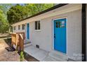 Close-up of a bright blue front door with glass inserts and a matching storm door at 880 Legion Club Rd, Salisbury, NC 28146