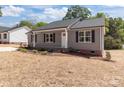Charming single-story home featuring a well-manicured lawn and inviting front porch, perfect for relaxing evenings at 104 Cleveland Ave, Albemarle, NC 28001