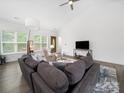 Bright living room featuring vaulted ceiling, modern furnishings, and wood flooring at 11104 Pine Grove Ave, Mint Hill, NC 28227