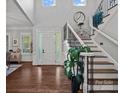 Bright foyer with hardwood floors, a staircase with iron railings, and sidelights by the front door at 116 Anderson Farm Ct, Mooresville, NC 28117