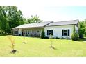 Charming single-story home with a well-manicured lawn and inviting front porch at 129 Devon Dr, Heath Springs, SC 29058