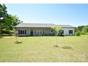 Single-story home featuring a well-manicured front lawn at 129 Devon Dr, Heath Springs, SC 29058