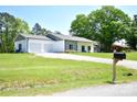Property featuring a two-car garage and a long gravel driveway at 129 Devon Dr, Heath Springs, SC 29058