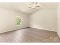 An empty bedroom with natural light, ceiling fan, and light-colored wood laminate flooring at 1550 Doran Ter, Richburg, SC 29729