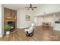 Bright living room features a stone fireplace, high ceilings, and modern decor at 1600 Sharon W Rd # 8, Charlotte, NC 28210