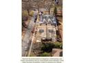 A beautiful aerial view shows four homes under construction, surrounded by trees and streets with parked cars at 1640 Ferncliff Rd, Charlotte, NC 28211