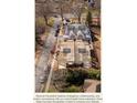 Aerial view of new construction homes with a street view and surrounding trees at 1628 Ferncliff Rd, Charlotte, NC 28211