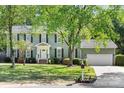 Inviting home features manicured lawn, traditional architecture, and a two-car garage at 16614 Beech Hill Dr, Huntersville, NC 28078
