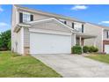 Charming two-story home with a two-car garage, light siding and a manicured front lawn at 1849 Meadow Crossing Dr # 118, Huntersville, NC 28078