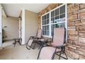 Relaxing front porch featuring comfortable seating and stone accents, perfect for enjoying the outdoors at 1849 Meadow Crossing Dr # 118, Huntersville, NC 28078
