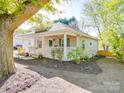 Single-story home with a inviting front porch, manicured landscaping, and neutral exterior paint at 215 6Th St, Belmont, NC 28012