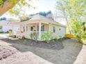 Single-story home with a inviting front porch, manicured landscaping, and neutral exterior paint at 215 6Th St, Belmont, NC 28012