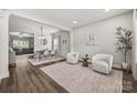 Bright living room featuring hardwood floors, neutral color palette, and open floor plan at 2624 St Helena Ct, Fort Mill, SC 29715