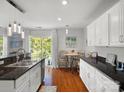Bright kitchen with white cabinets, granite countertops, eat-in area and stainless steel sink at 281 Loch Stone St, Fort Mill, SC 29715