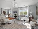 Bright and airy living room featuring hardwood floors, neutral tones, and a chandelier at 281 Loch Stone St, Fort Mill, SC 29715