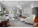 Bright living room featuring a chandelier, modern decor, and views to the kitchen at 281 Loch Stone St, Fort Mill, SC 29715