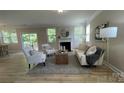 Bright living room boasts ample natural light, neutral tones, and a cozy fireplace at 3030 Collin House Dr, Fort Mill, SC 29715