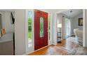 Welcoming entryway featuring a striking red door with decorative glass and sidelights, opening into a spacious, light-filled home at 3908 Brittany Ct, Indian Trail, NC 28079