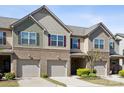 A townhome's exterior features brick accents, siding, and convenient attached garages at 4011 Black Walnut Way, Indian Land, SC 29707
