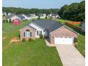 A cozy home with a two-car garage, brick accents, and a well-maintained lawn in a friendly neighborhood at 4193 He Propst Rd, Maiden, NC 28650