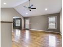 Open living room featuring hardwood floors, neutral walls, ceiling fan, and an arched doorway at 4193 He Propst Rd, Maiden, NC 28650