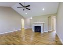 Spacious living area with hardwood floors, a fireplace, ceiling fan, and neutral color scheme at 4193 He Propst Rd, Maiden, NC 28650