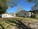 A full property view, showing the house and the detached garage with a large yard at 5364 Millersville Rd, Taylorsville, NC 28681