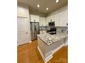 Modern kitchen features stainless steel appliances, granite countertops and white cabinetry at 627 N Alexander St, Charlotte, NC 28202
