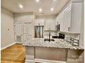 Modern kitchen features stainless steel appliances, granite countertops and white cabinetry at 627 N Alexander St, Charlotte, NC 28202