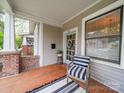 Relaxing front porch featuring painted wood floors, and comfortable seating, perfect for enjoying the outdoors at 705 N Fulton St, Salisbury, NC 28144
