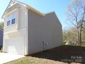 Side view of a modern two-story home highlighting its exterior siding and architectural lines at 719 N Kelly St, Statesville, NC 28677