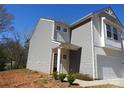 View of a modern two-story home with a gray siding, showcasing the property's design at 719 N Kelly St, Statesville, NC 28677