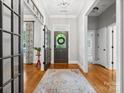 Elegant foyer with hardwood floors, a decorative rug, and an open view of the home's interior at 894 Stratford Run Dr, Fort Mill, SC 29708