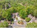 Overhead view of the homes showing their proximity to the golf course and lush tree coverage surrounding the neighborhood at 9012 Saint Thomas Ln, Charlotte, NC 28277
