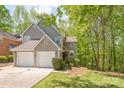 Charming two-story home with attached garage and well-maintained lawn, framed by mature trees at 9012 Saint Thomas Ln, Charlotte, NC 28277