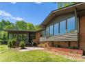 Modern brick home featuring an expansive window wall for natural light and outdoor views at 916 E Park Dr, Lincolnton, NC 28092