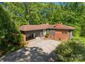 Brick home featuring covered parking, lots of trees and a beautiful lawn at 916 E Park Dr, Lincolnton, NC 28092