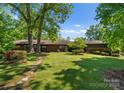 Brick home featuring mature trees, landscaping and a beautiful lawn at 916 E Park Dr, Lincolnton, NC 28092