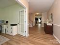 Welcoming foyer with wood floors leading to a staircase and the living areas at 1033 Lilly Pond Dr, Fort Mill, SC 29715