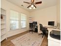 Bright home office featuring large windows, ample workspace, and neutral decor at 1033 Lilly Pond Dr, Fort Mill, SC 29715