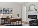 Office area boasts wood floors, a modern fireplace, and stylish decor at 1112 Allman Ext, Mount Pleasant, NC 28124