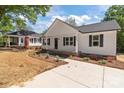 Charming one-story home with white siding, black shutters, and a cozy front porch at 112 Cleveland Ave, Albemarle, NC 28001