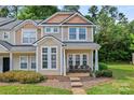 Attractive townhome with a cozy porch, showcasing curb appeal and a well-maintained lawn at 1161 Constitution Park Blvd, Rock Hill, SC 29732