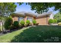 Charming single-story brick home with lush lawn and manicured bushes lining the front, creating a welcoming appeal at 123 Shoreview Dr, Mooresville, NC 28117